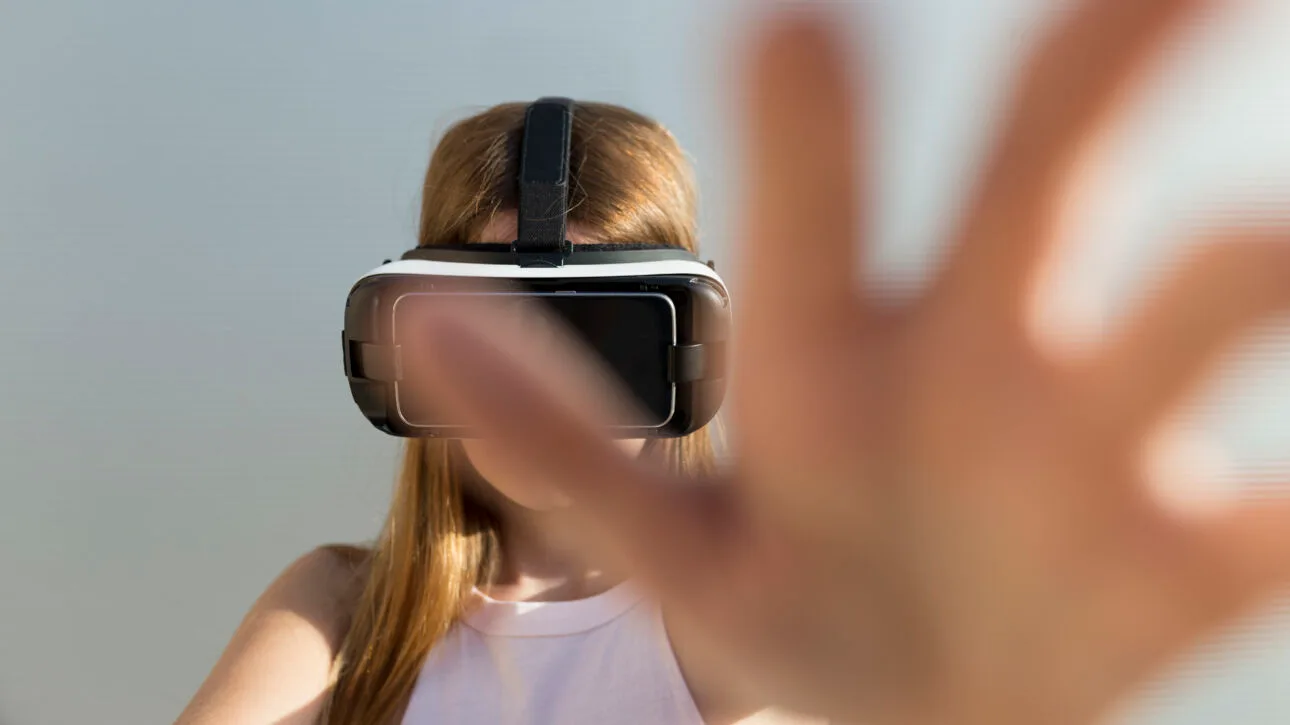 young woman using vr googles reaching with her ha 2023 11 27 04 57 14 utc scaled